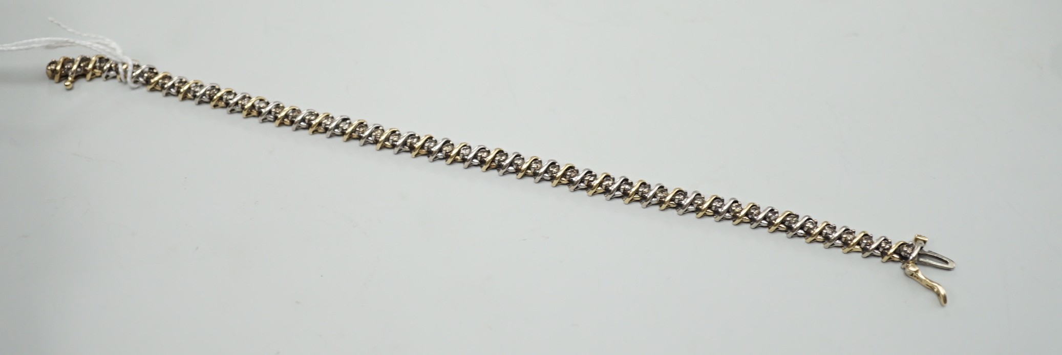 A modern two colour 14k and diamond chip set bracelet, 18.5cm, gross weight 12.7 grams.